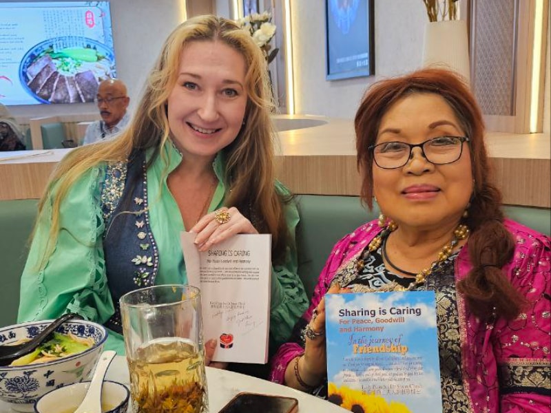 Puan Sri Susan Cheah signing her book to Natalya, 2024